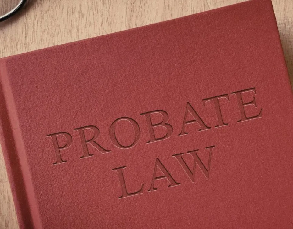 A red book on a table. The book says 'Probate Law' on the front cover.