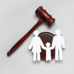 An image showing a judges' gavel with a paper cut-out of a family.